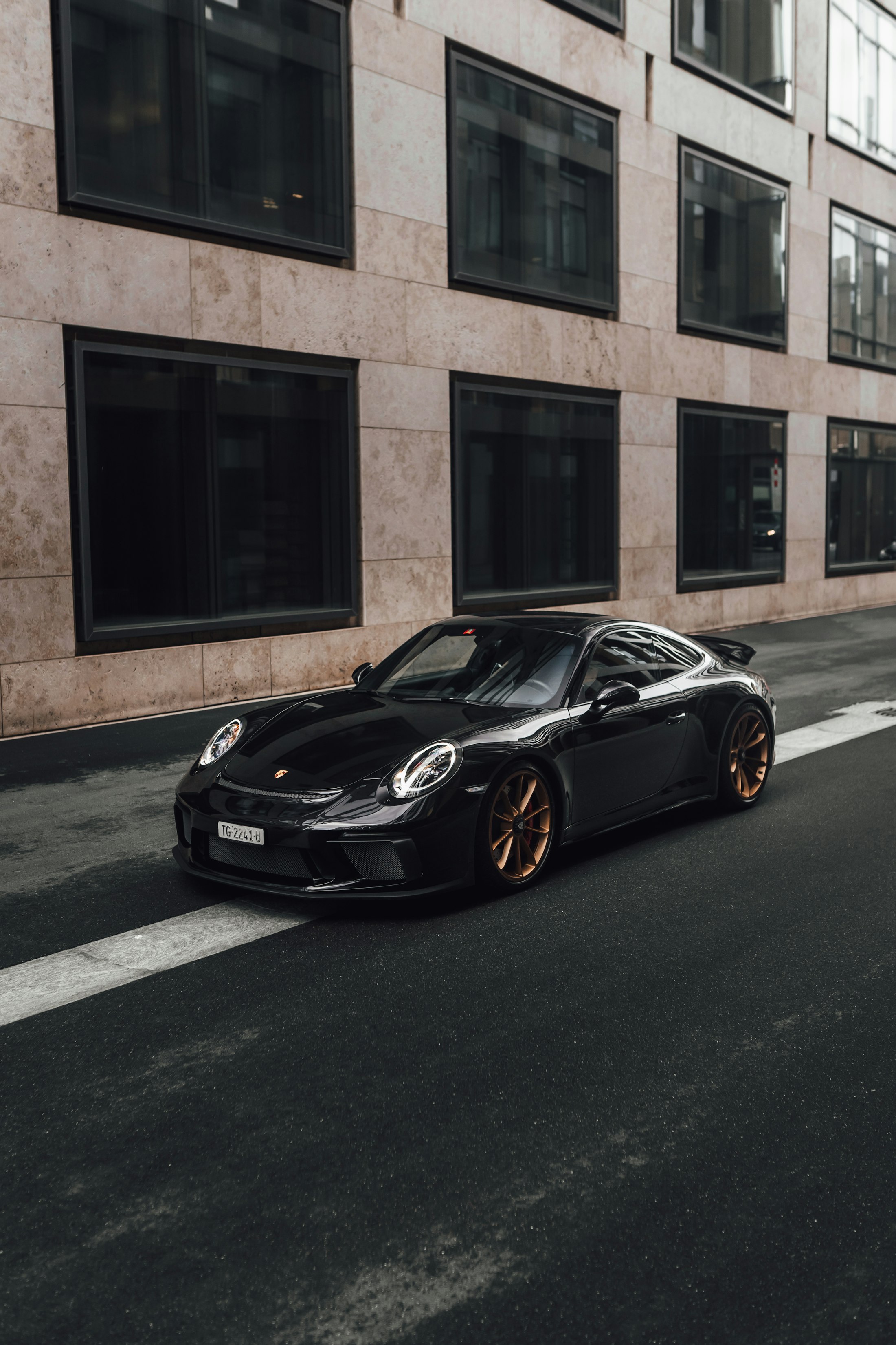 Black Porsche 911 GT3 Touring on a city street
